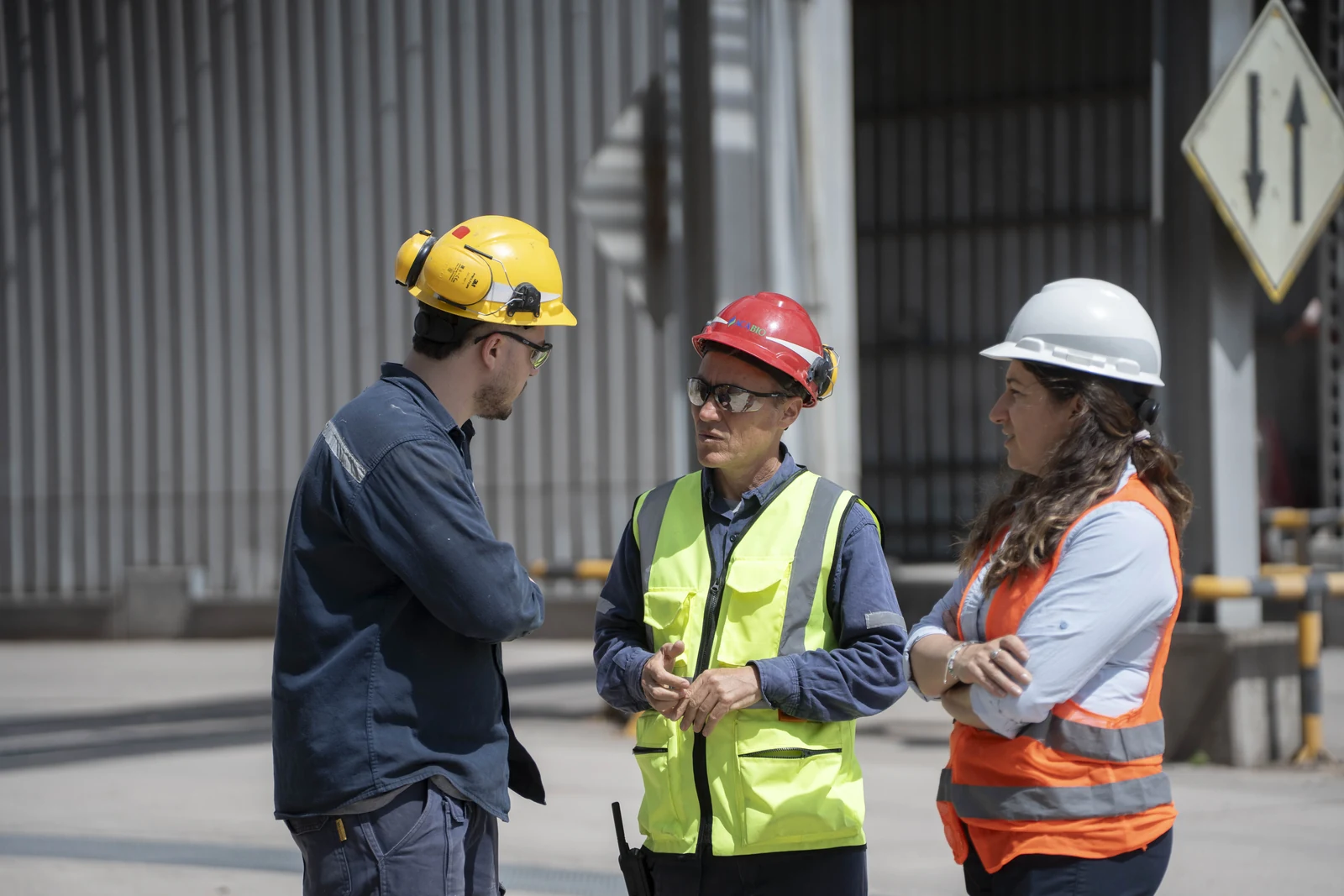 Tres colaboradores de ACA BIO conversan en el sector industrial.